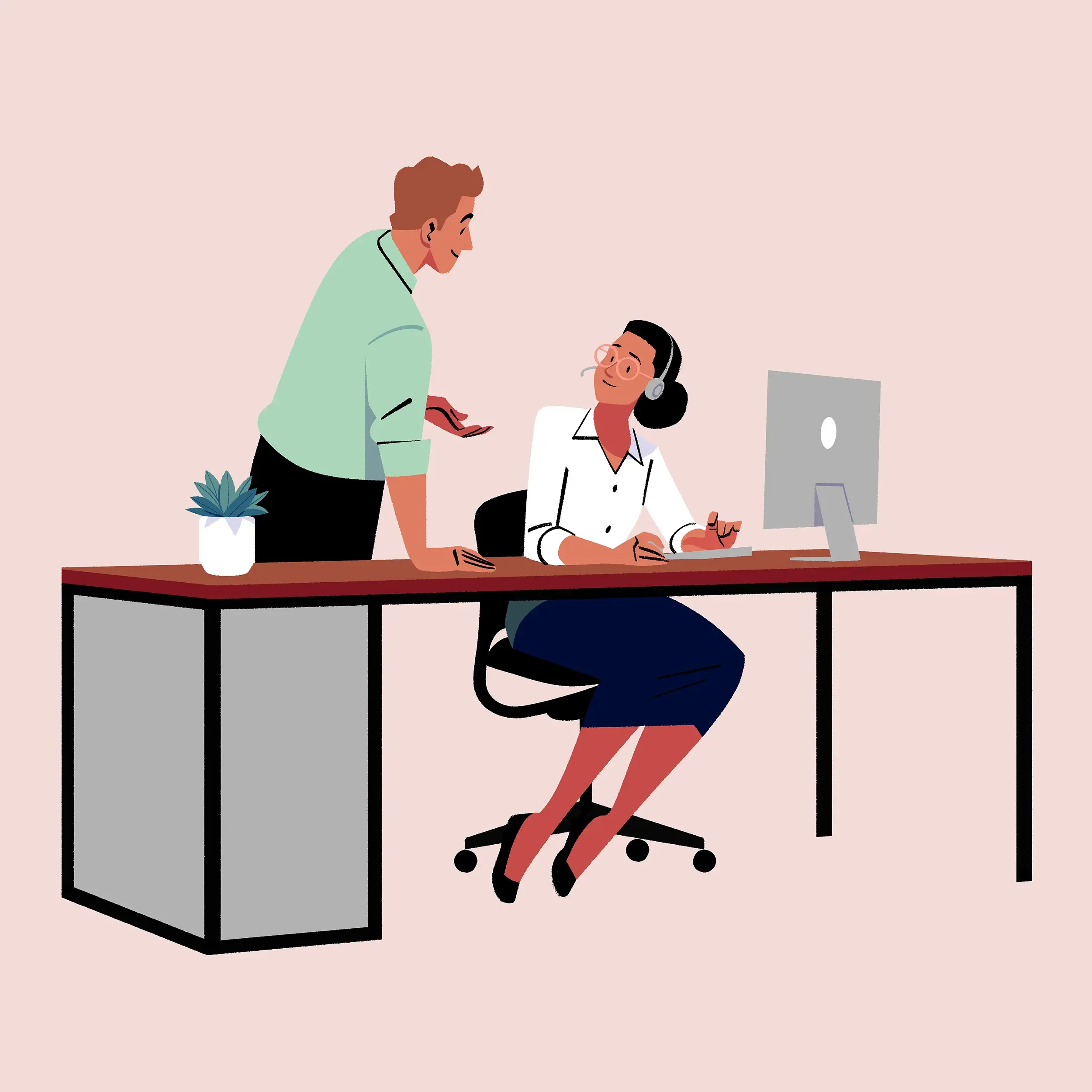 Man standing next to woman at a desk