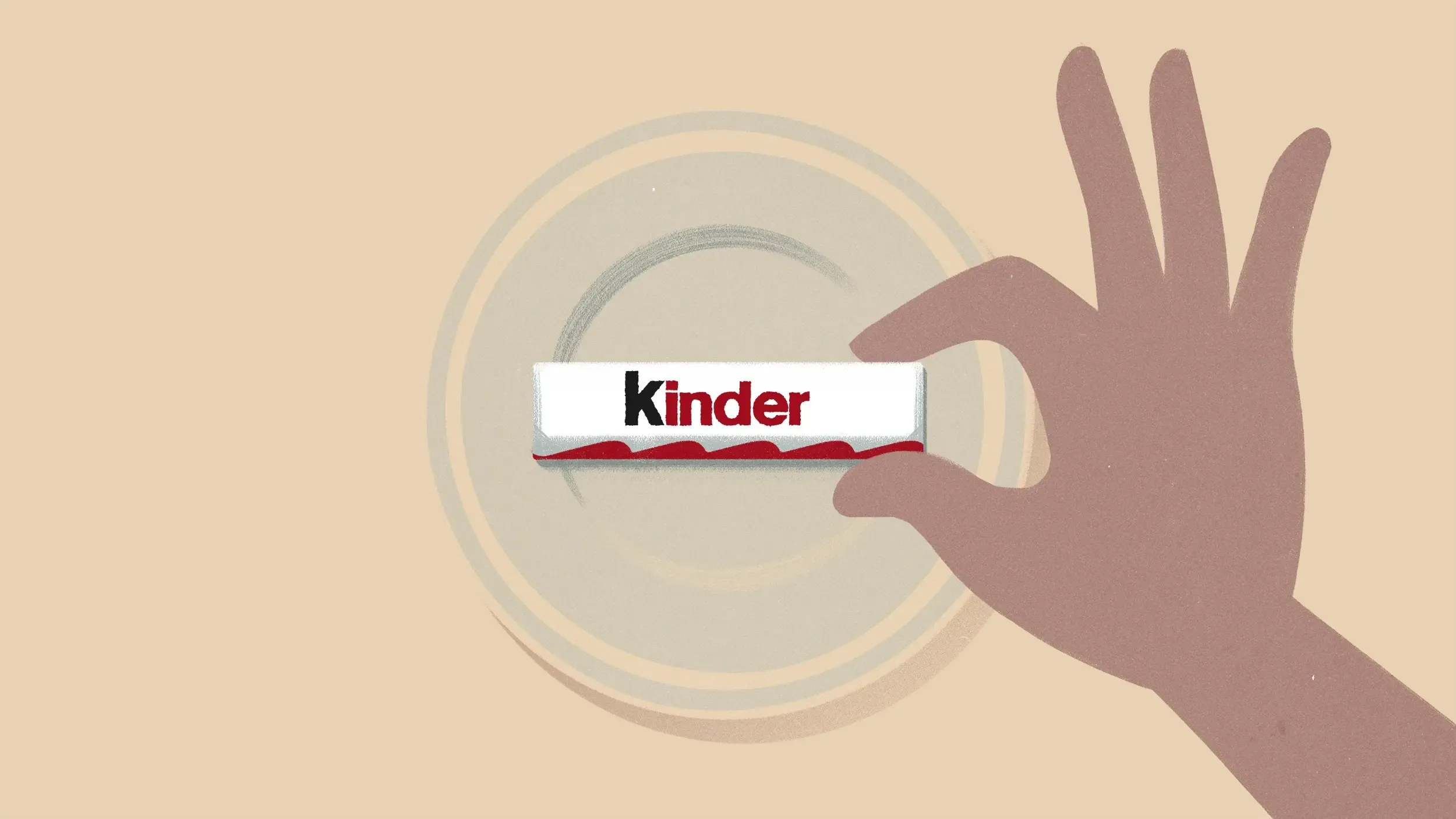 A hand picking up a Kinder bar